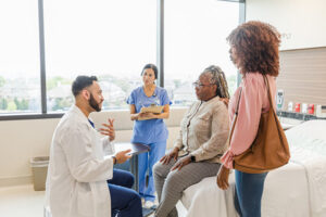 Older adult talking with doctor