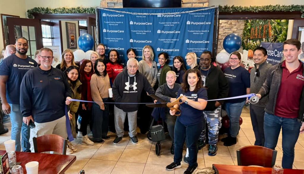 The Oswego team celebrates the rebrand with a ribbon-cutting ceremony