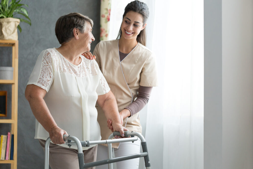 PurposeCare caregiver helping a client walk
