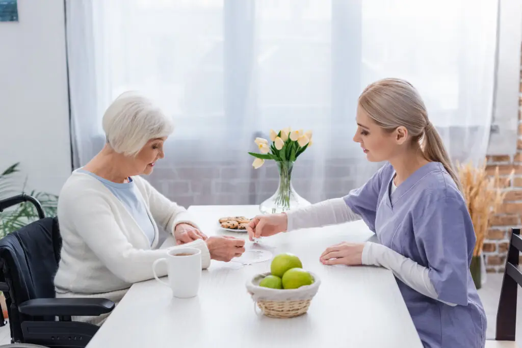 Home caregiver completing jigsaw puzzle with client.